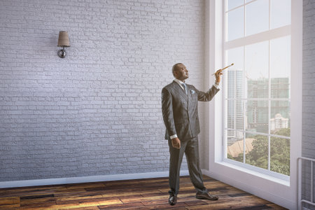 Conceptual image of ambitious and creative businessman in black suit holding paintbrush in handの写真素材