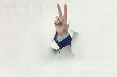 Woman hand victory sign gestureの写真素材