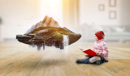 Little girl reading a book