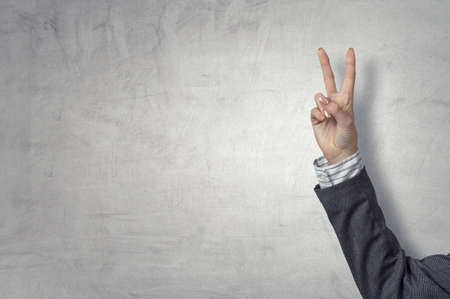 man hand victory sign gestureの写真素材
