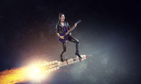 Young and beautiful rock girl playing the electric guitarの写真素材