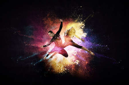 Two dancers against abstract colourful backgroundの写真素材