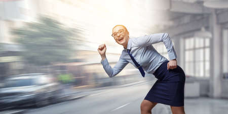 Portrait of business woman runningの写真素材
