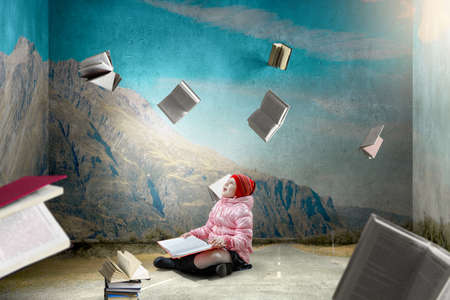 Little girl reading a bookの写真素材