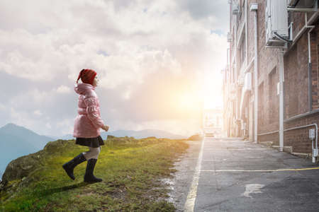 Little girl walking a landscapeの写真素材