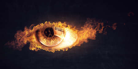 Macro image of human eye with fire flamesの写真素材