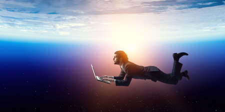 Joyful happe businessman levitating horizontallyの写真素材