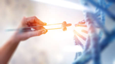 DNA molecules design with female hand holding pincers. Mixed mediaの写真素材