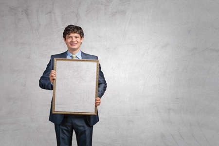 Man holding blank poster . Mixed media