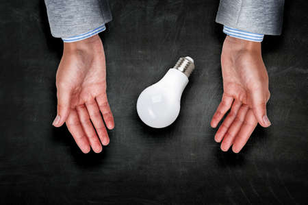 Light bulb between hands . Mixed mediaの写真素材