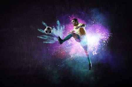 Boy playing soccer hitting the ballの写真素材
