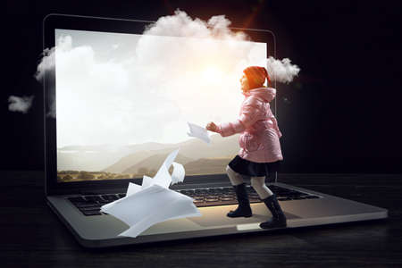 Little girl walking out of computer sreenの写真素材