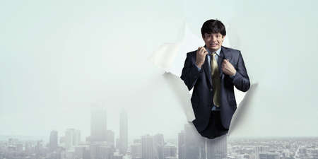 The sad and puzzled young man in a business suitの写真素材