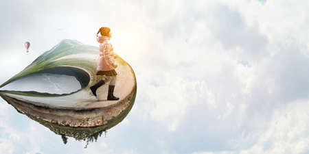 Little girl walking a landscapeの写真素材