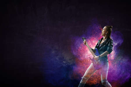 Young and beautiful rock girl playing the electric guitarの写真素材