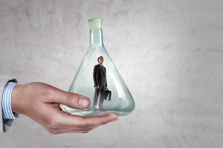 Business man standing inside a glass bottle