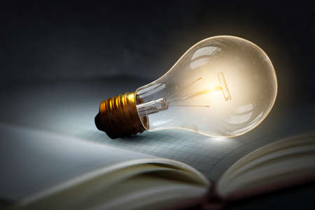 Huge light bulb glowing in the darkness