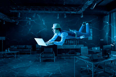 Man with laptop underwater . Mixed media