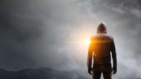 Silhouette of man in hoody