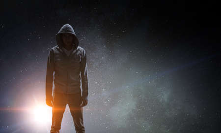 Silhouette of man in hoodyの写真素材