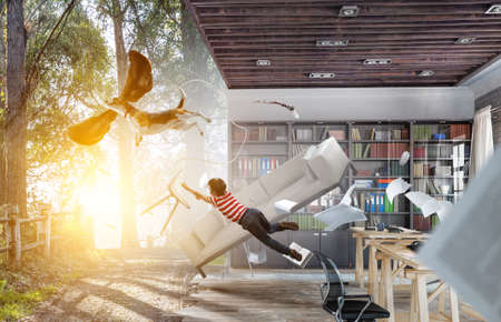 Boy with a dog flying through the air with his earsの写真素材