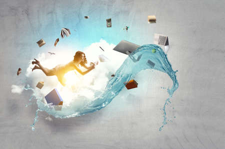 Young woman levitates while reading a bookの写真素材