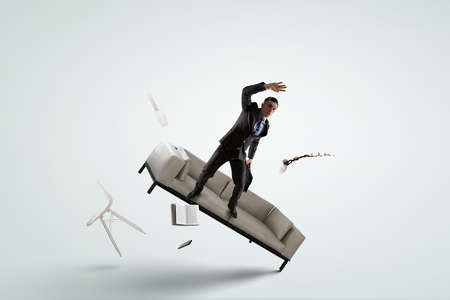 Scared businessman in a falling positionの写真素材