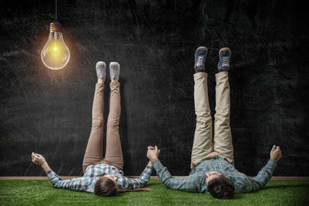 Couple relaxing with their legs up on wallの写真素材