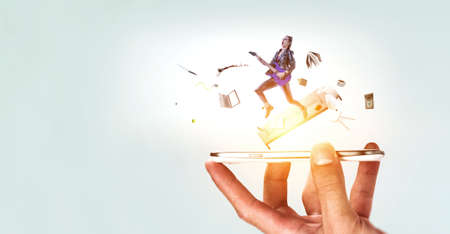 Young and beautiful rock girl playing the electric guitar . Mixed mediaの写真素材