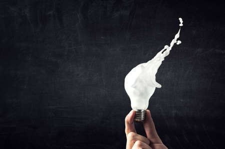 Light bulb with white glass splashの写真素材