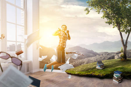 Happy businessman jumping high . Mixed mediaの写真素材