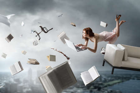 Young woman levitates while reading a book