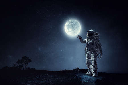 Astronaut walking on an unexplored planetの写真素材