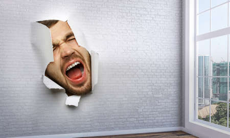 Male face through the hole in paper
