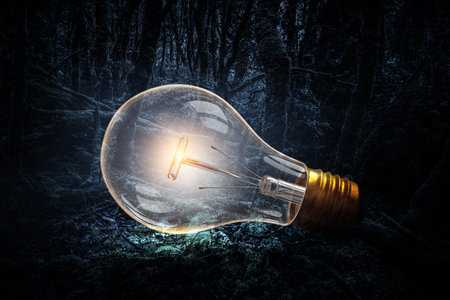 Huge light bulb glowing in the darkness
