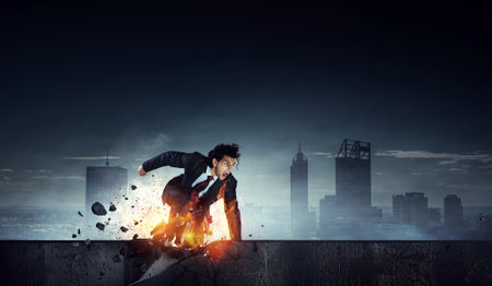 Determined businessman leaving fire trails on asphalt . Mixed mediaの写真素材