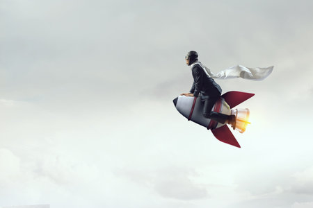 Businessman on a rocket . Mixed mediaの写真素材