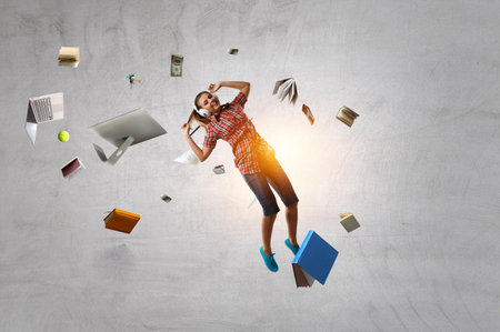 Woman wearing headphones jumping . Mixed mediaの写真素材