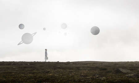 Back view of young businessman while standing with mist backgroundの写真素材