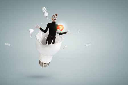 Female mime and light bulbの写真素材