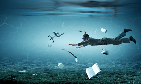Young businessman in suit swimmingの写真素材