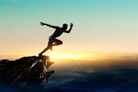 Man running against sunset sky background