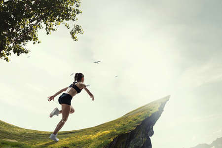 Woman running against natural landscapeの写真素材
