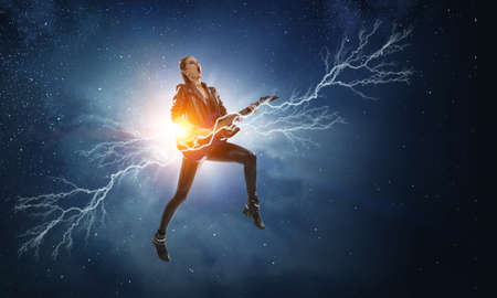 Young and beautiful rock girl playing the electric guitarの写真素材