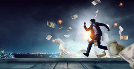 Portrait of energetic businessman running . Mixed mediaの写真素材