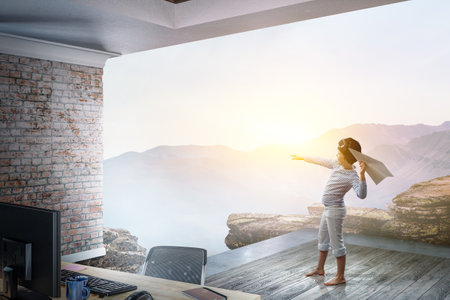 Happy kid playing with paper airplaneの写真素材