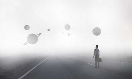 Back view of young businessman while standing with mist space backgroundの写真素材