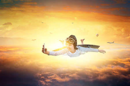 Happy little boy flying wearing helmetの写真素材