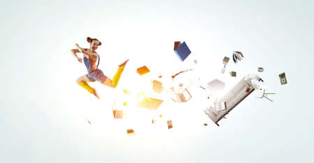 Young woman jumping in the air . Mixed mediaの写真素材