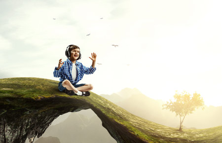 Kid wearing headphones . Mixed mediaの写真素材